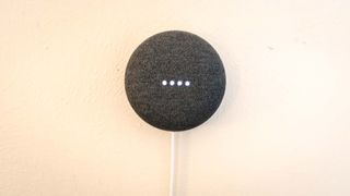 A wall-mounted Google Nest Mini