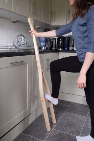 The ‘One Step Ladder’ by Cameron Rowley. A 'Y' shaped step ladder leaning against a kitchen counter with a womans foot on the step.