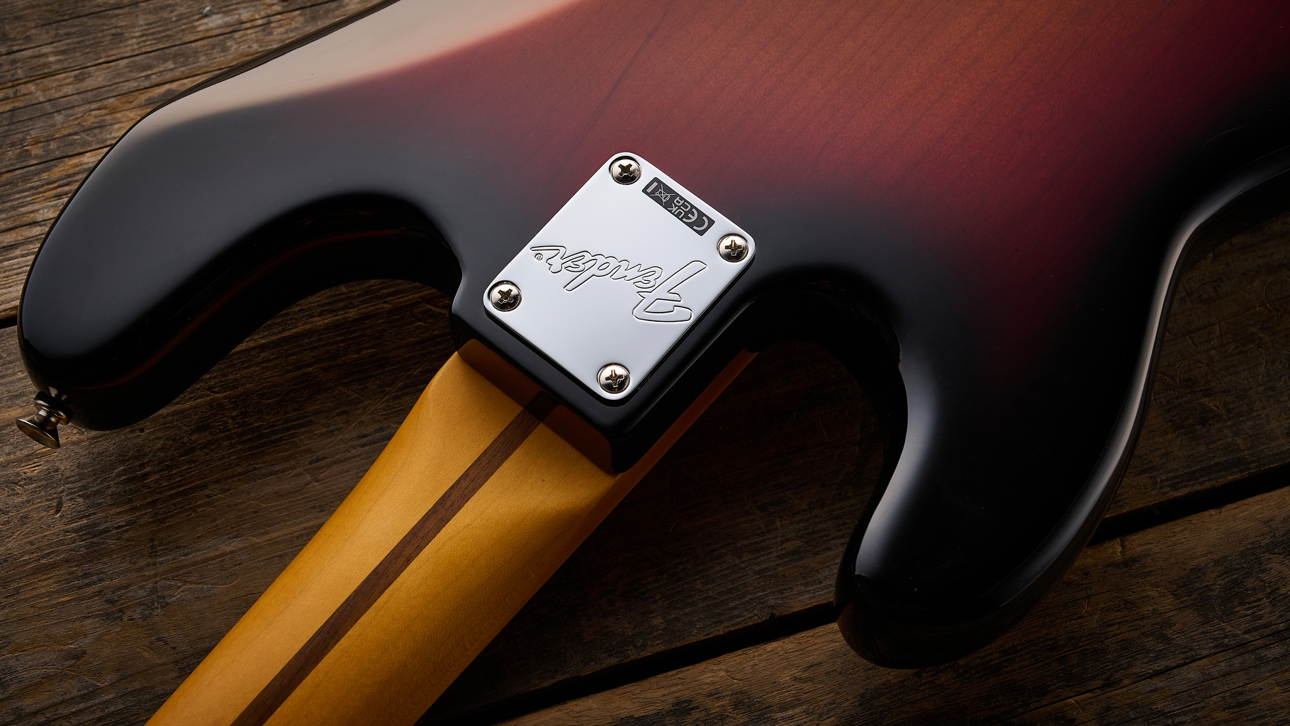 Fender American Professional Classic Precision Bass in 3-Color Sunburst shot on wood floor boards