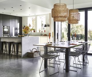 industrial style kitchen diner with concrete cabinets and floor
