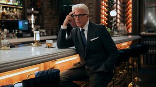 Charles sits at a bar with a drink in A Man on the Inside season 2