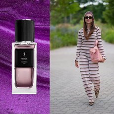 A woman wearing a purple, striped, 2-piece set and holding a pink bag. She is next to a bottle of YSL's Muse. 