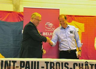 UCI president Pat McQuaid, left, and Tour de France director Christian Prudhomme shake hands at the press conference introducing the Tour of Beijing.