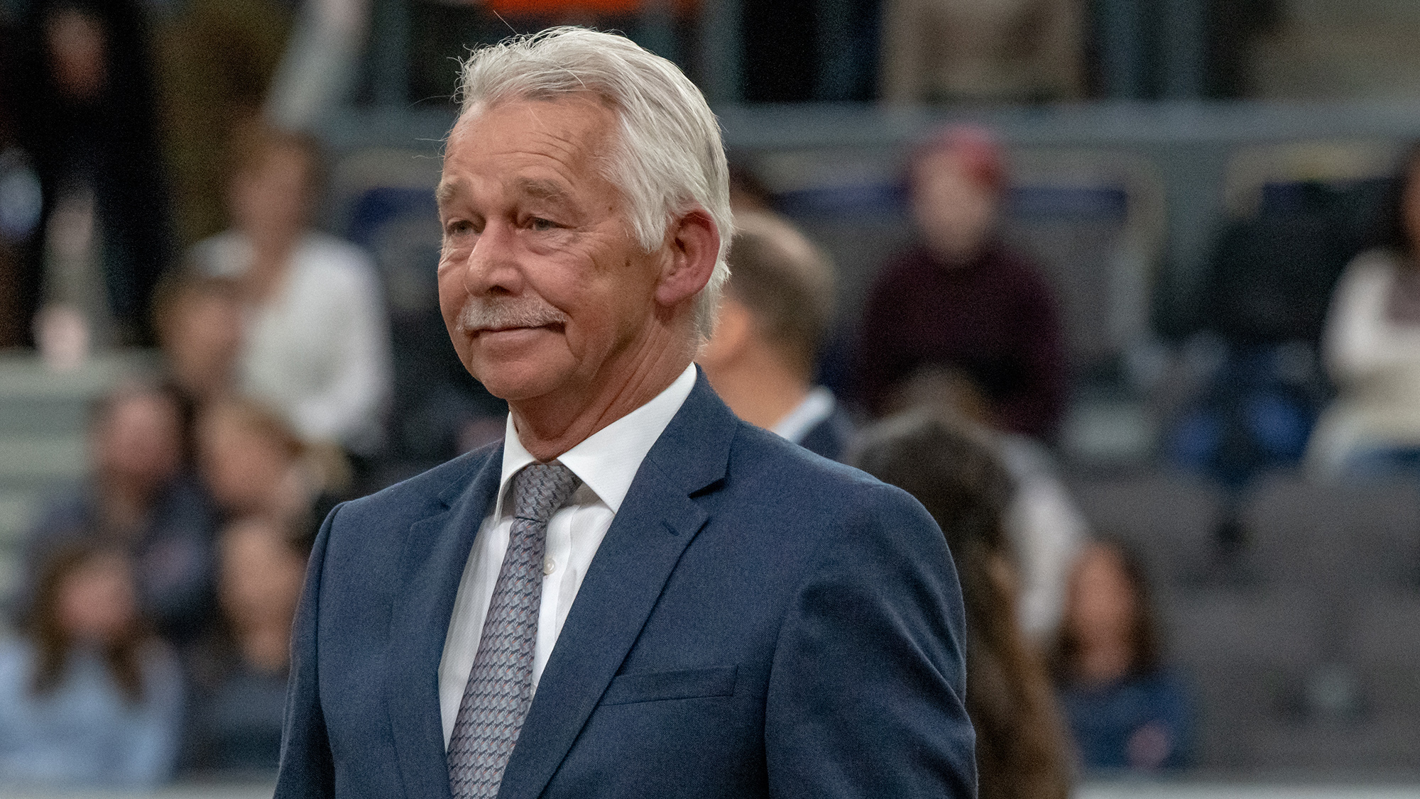 Top dressage judge Stephen Clarke wearing a blue jacket, white shirt and grey tie