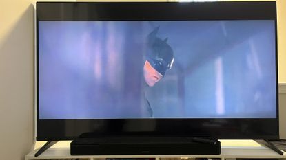 Bose Smart soundbar on TV stand with TV showing The Batman