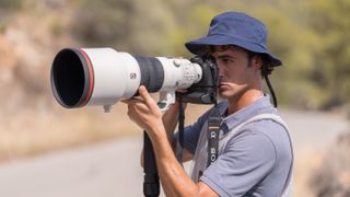 Man using a Sony A9 III camera with Sony FE 300mm f2.8 GM OSS lens