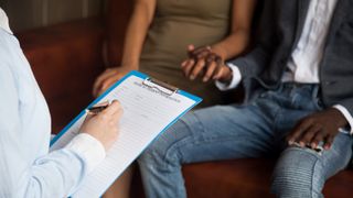 black couple providing medical information to health care worker