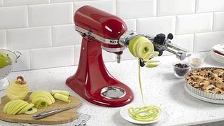 Red KitchenAid stand mixer with spiralizer attachment on a kitchen worktop