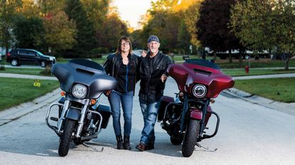 Kip Rupple and Roni Kramer posing next to their motorcycles