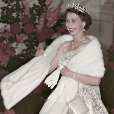 Queen Elizabeth wearing a stole and diamond tiara with a white gown