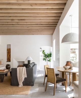 light and airy living space with white walls, wooden ceiling beams