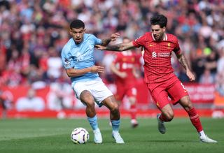 LIVERPOOL, ENGLAND - SEPTEMBER 14: Morgan Gibbs-White of Nottingham Forest holds off a challenge Dominik Szoboszlai of Liverpool during the Premier League match between Liverpool FC and Nottingham Forest FC at Anfield on September 14, 2024 in Liverpool, England. (Photo by Alex Livesey - Danehouse/Getty Images)