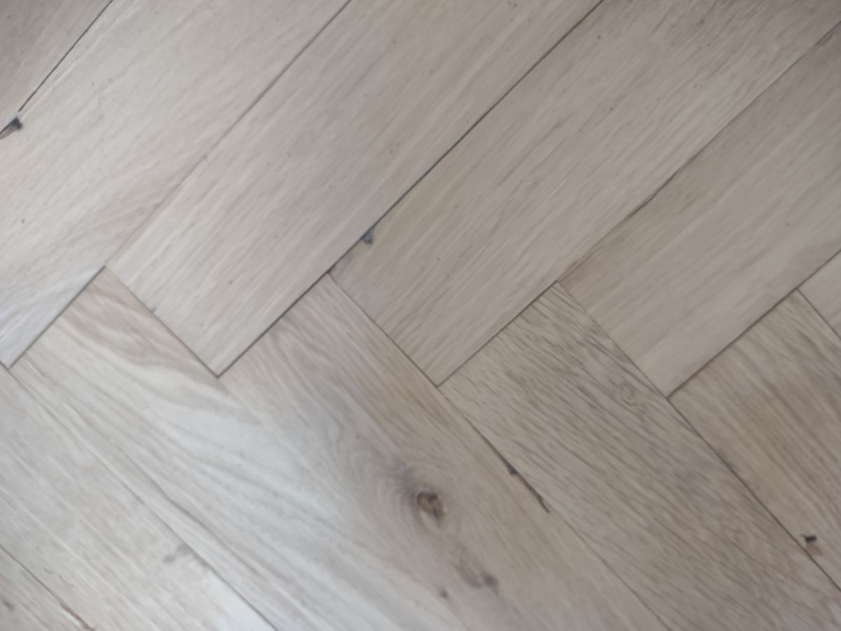 A well sanded wooden floor in a herringbone style