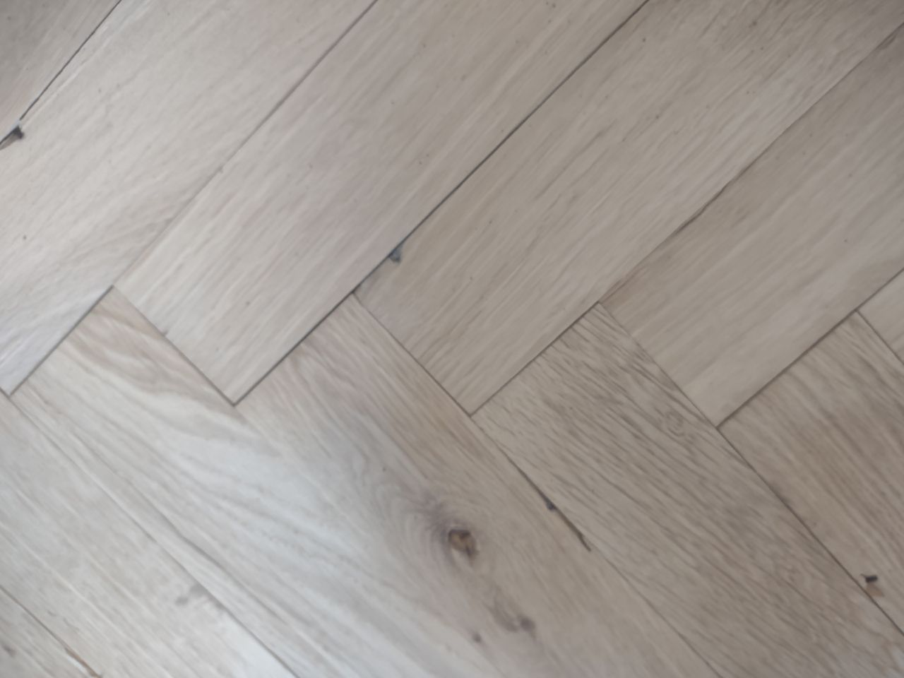 A well sanded wooden floor in a herringbone style