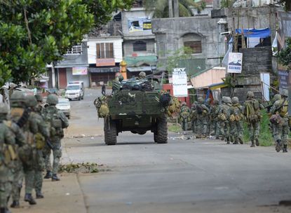 Government forces combat ISIS-linked rebels in the Philippines