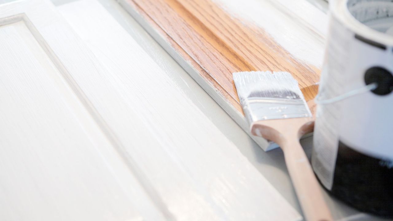 Someone priming cabinet doors white