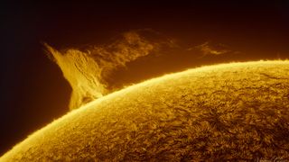 closeup shot of the sun's surface with yellowish band of plasma dancing above it