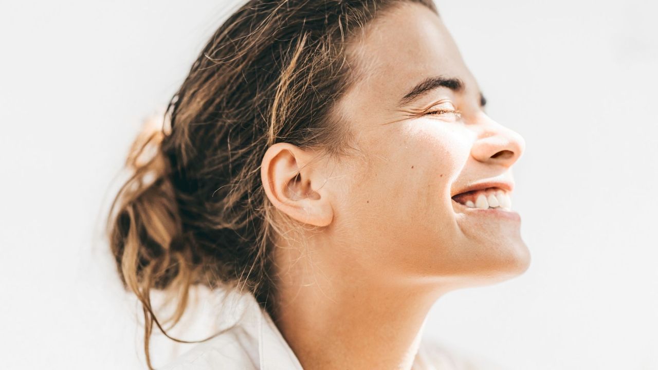 A woman smiling at the sun