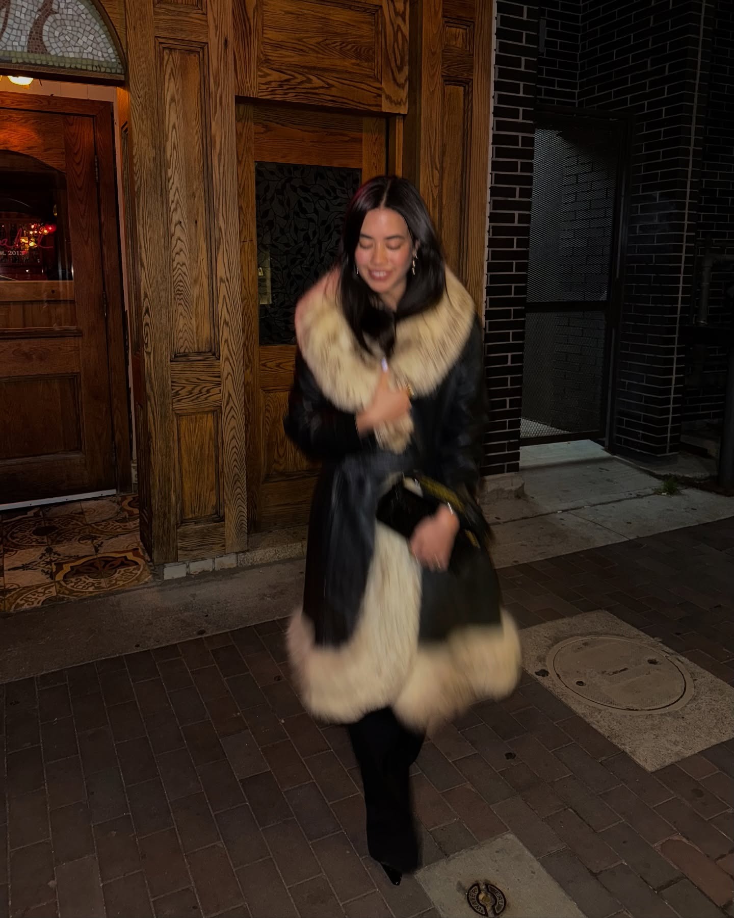 Fashion person Sasha Mai wears a faux fur jacket outfit.