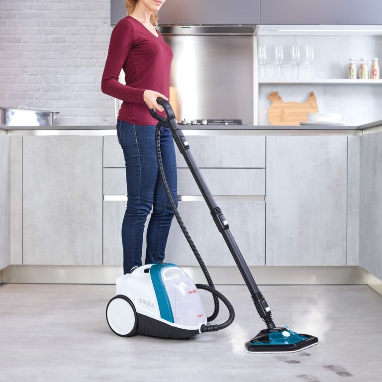 Woman cleaning dirty marks on kitchen floor with the Polti Vaporetto steam cleaner