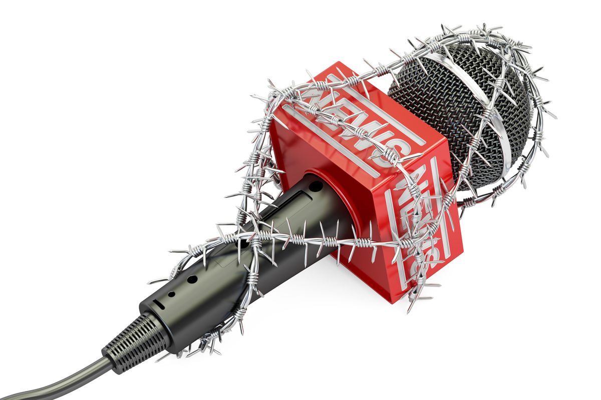 A microphone wrapped in barbed wire.