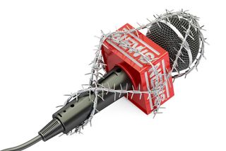 A microphone wrapped in barbed wire.