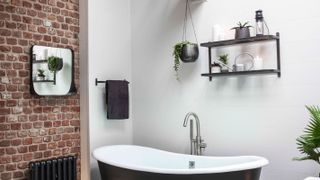 bathroom with exposed brick wall