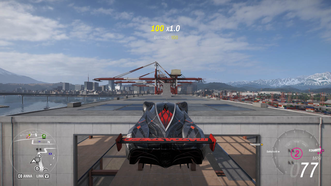 Forza Horizon 6 Tokyo City Treasure Hunt location: A Mazda Furai driving across a gap between two warehouses.
