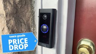 Image of the Ring Video Doorbell Wired installed next to a door, on a wall with a 'price drop' tag