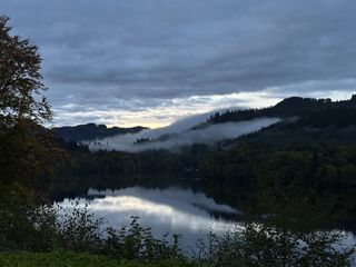 Mist rolls in over the trees and hills of Perthshire, Scotland