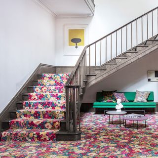 room with grey staircase and floral printed steps