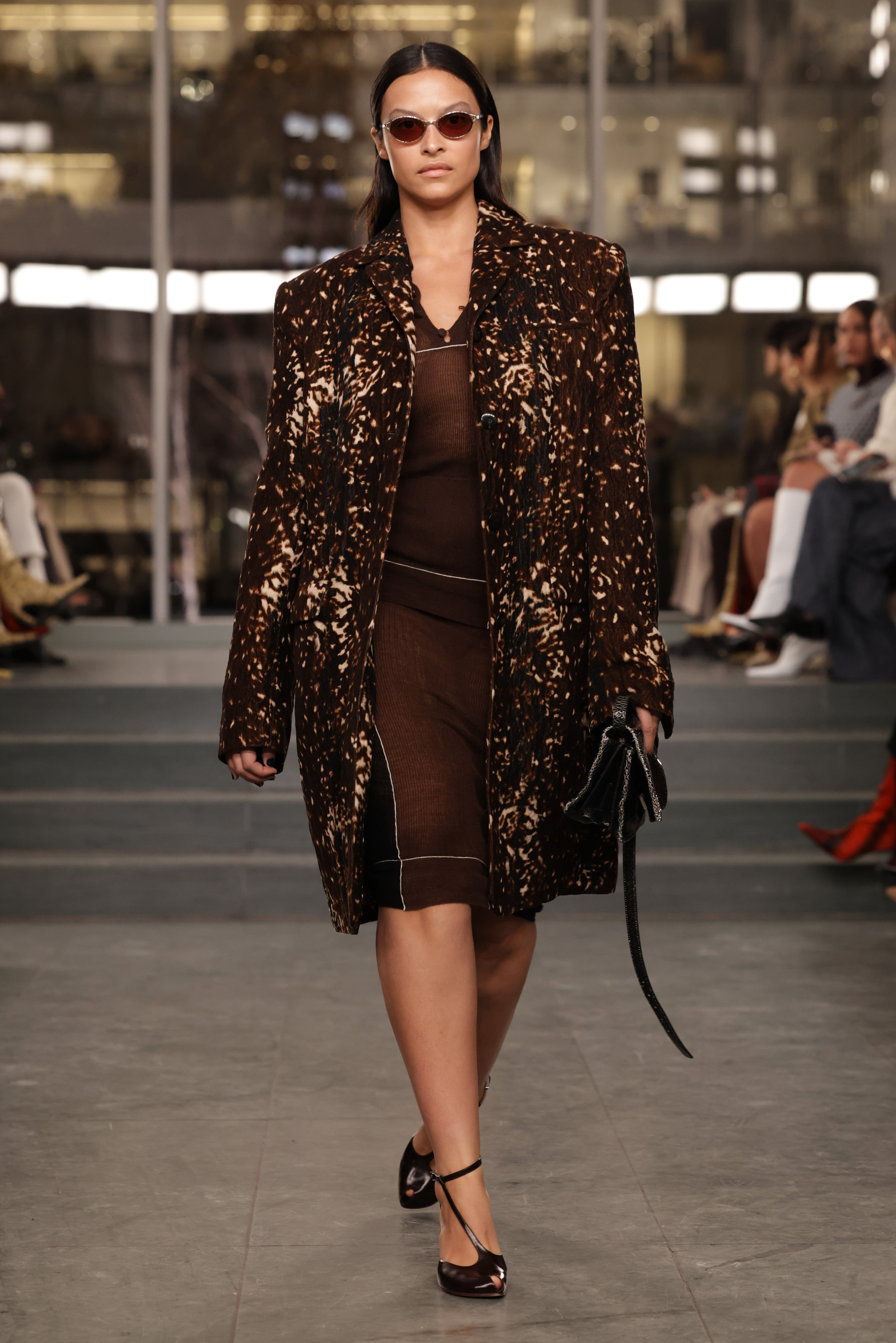 Image of the Tory Burch autumn/winter 2025 runway. The model wears the deer print trend.