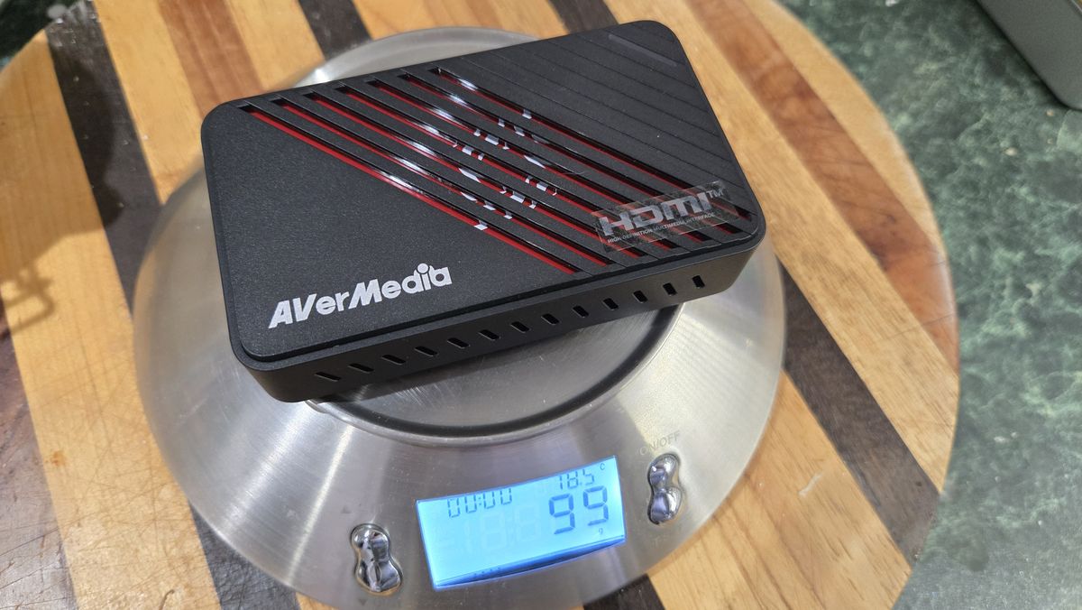 An AverMedia external capture card on a chair.