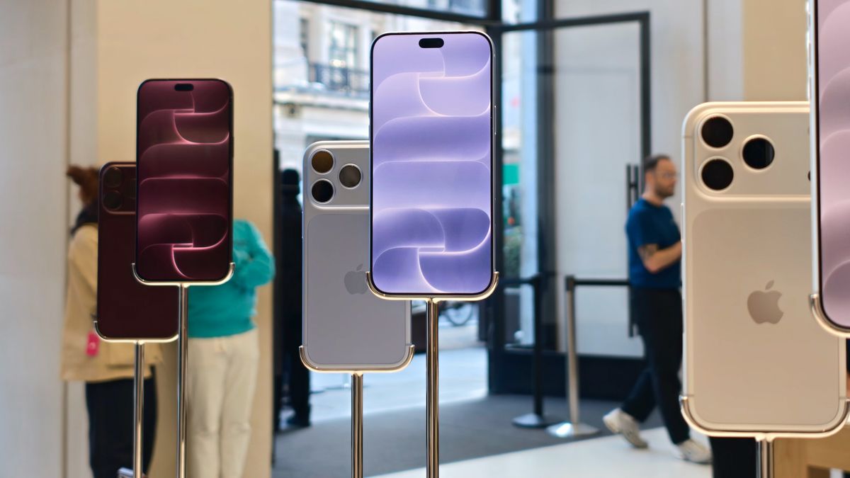 Burgundy and silver iPhone 18 Pro models displayed on metal stands inside an Apple Store.