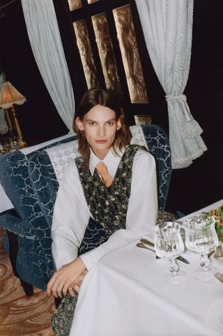 Staff member sits at dining table on Orient Express