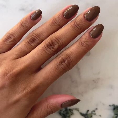 A close up of a brown manicure