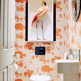 cloakroom with bold orange and white wallpaper