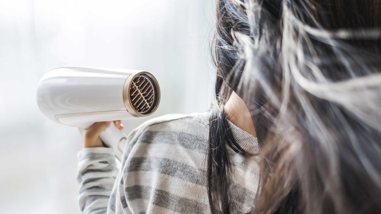 Best hair dryer: blow drying long dark hair shot from behind