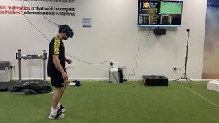 A football player using a VR headset and Rezzil's training software