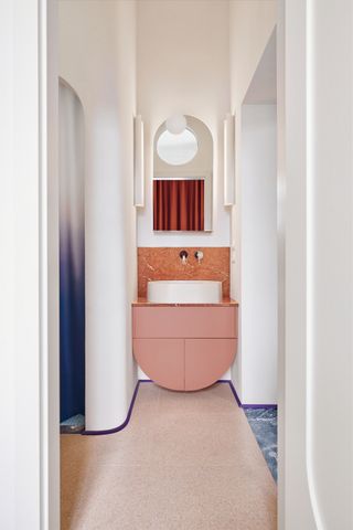 a modern bathroom with a curved vanity