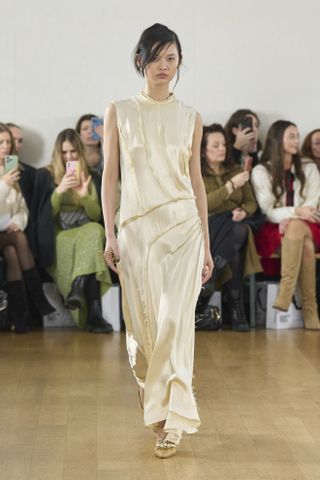 Woman in ivory satin dress on Eudon Choi runway