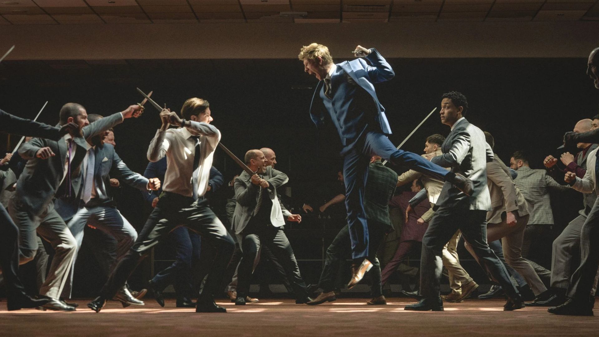 Two groups of boys lunge towards each other with swords