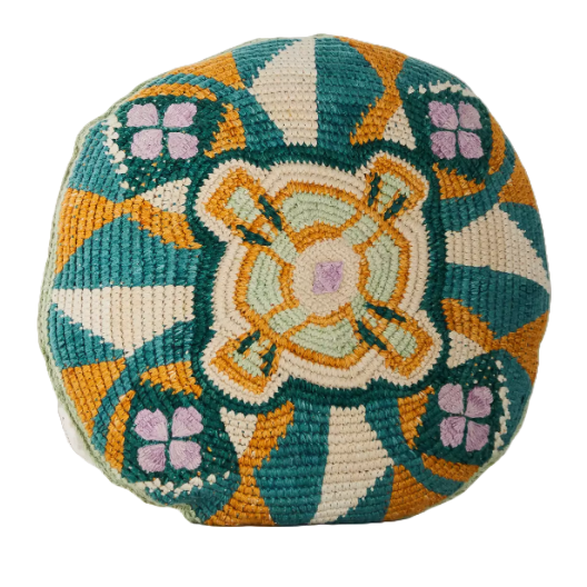 a round cushion with an orange, green and beige geometric pattern on it