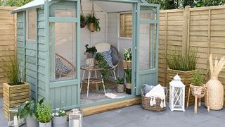 green summer house shed with living area and patio