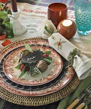 Christmas place setting with personalised nametag, patterned plates and foliage