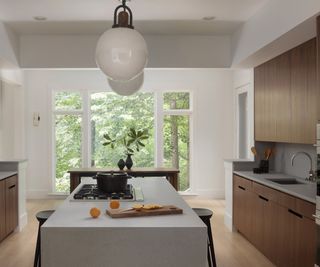 kitchen with walnut cabinetry and view of dining nook with large windows