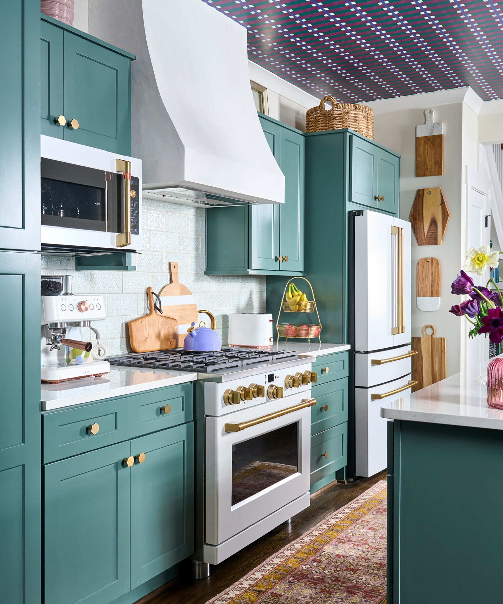 A green kitchen with white and gold appliances