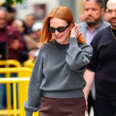 Julianne Moore wearing a gray sweater and brown skirt in NYC