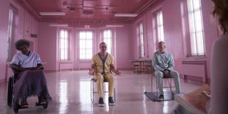 Elijah Price, Kevin Crumb and David Dunn sit in chairs in a pink room in 'Glass'