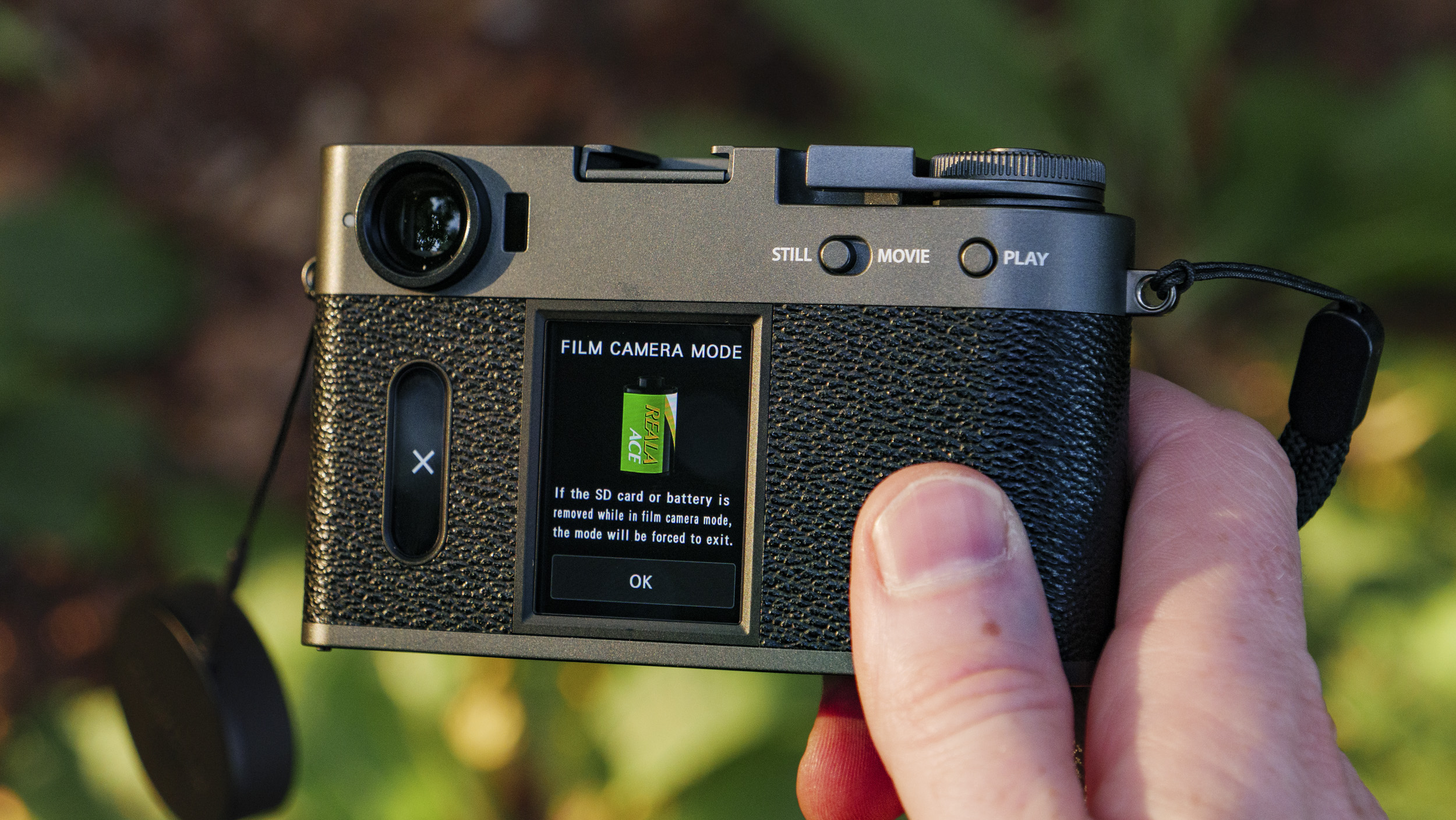 Fujifilm X half camera in the hand at golden hour